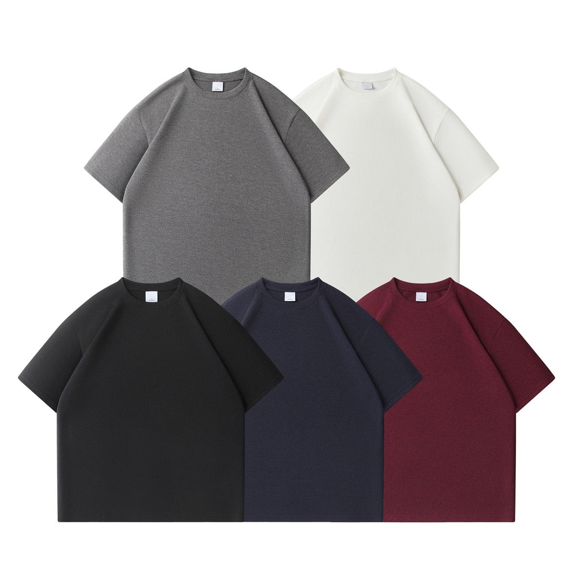 Five plain short-sleeve crew-neck T-shirts shown from the front in gray, white, black, navy, and burgundy.