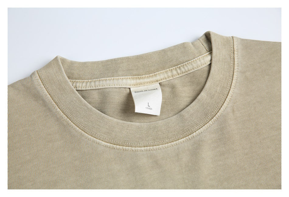 Close-up of the T-shirt's ribbed crew neck and inner size label marked L.