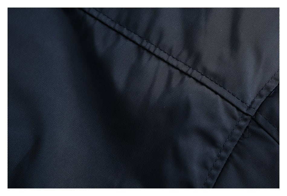 Close-up of dark navy fabric showing intersecting stitched seams.