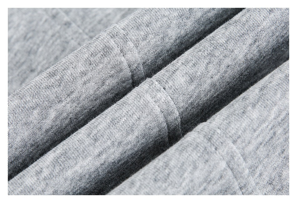 Close-up of heather gray knit fabric arranged in soft folds.