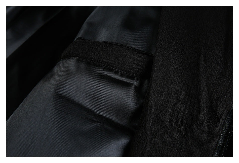 Close-up of black garment lining and a stitched seam beside the outer fabric.