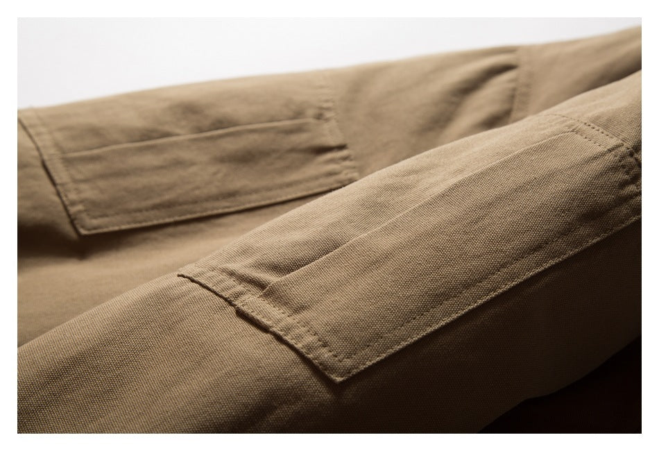 Close-up of a tan-brown garment pocket and its stitched edges.