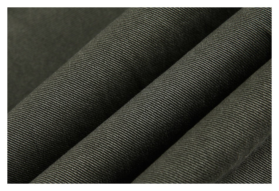 Macro view of dark olive-gray fabric with a fine diagonal weave.