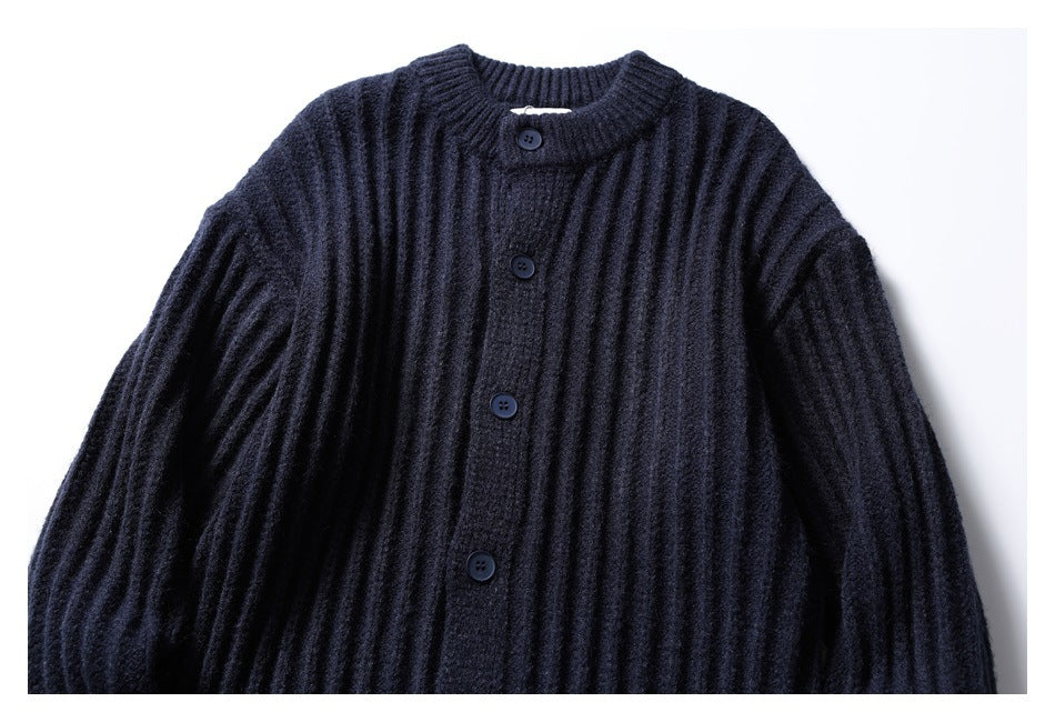Front view of a dark navy ribbed knit cardigan with a round neckline and button front, laid flat.