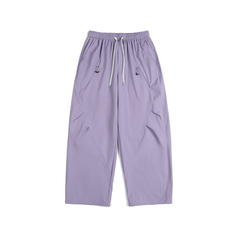 Purple wide-leg drawstring pants with diagonal seams and hip pockets, flat lay front view