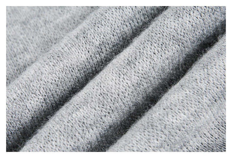 Macro view of the gray garment's knit texture draped in soft folds.