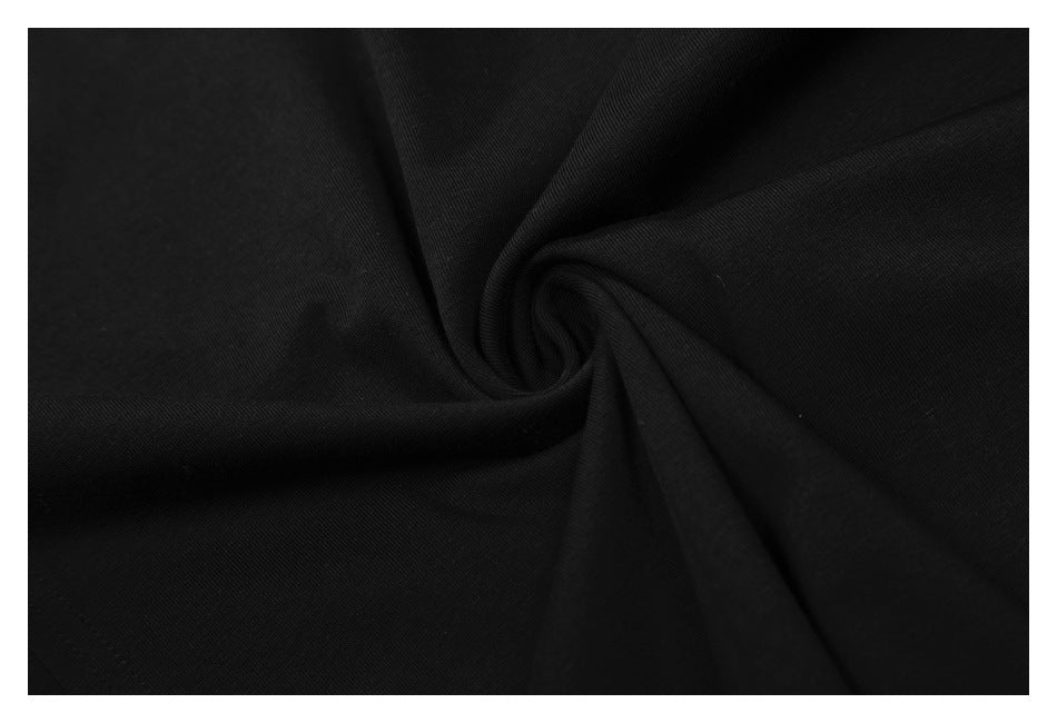 Close-up of black fabric gathered into a soft spiral fold.