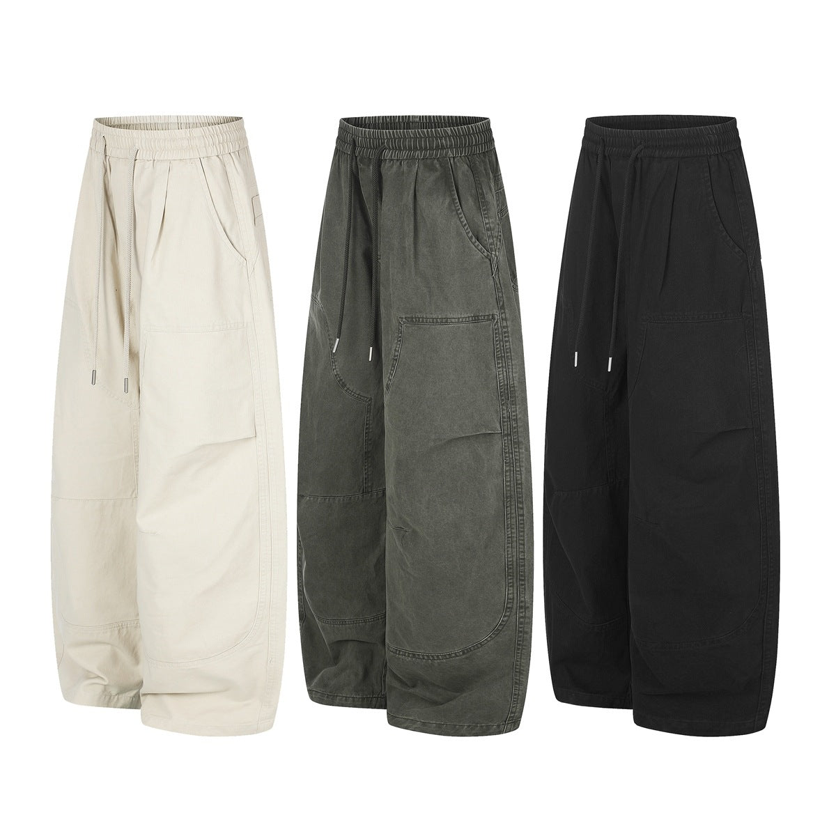 Three pairs of wide-leg trousers shown from the front in cream, washed olive, and black, with elastic waists and large