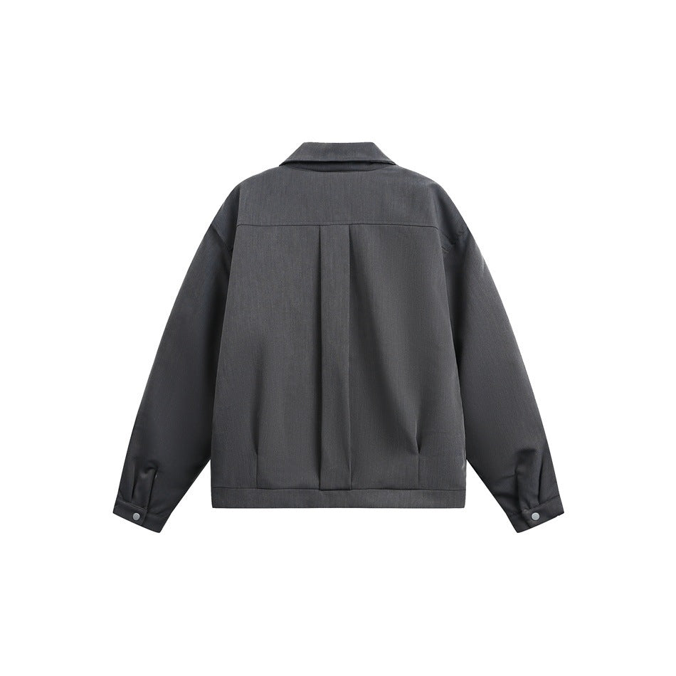 Back view of a charcoal gray jacket with a center pleat, pointed collar, and buttoned cuffs.