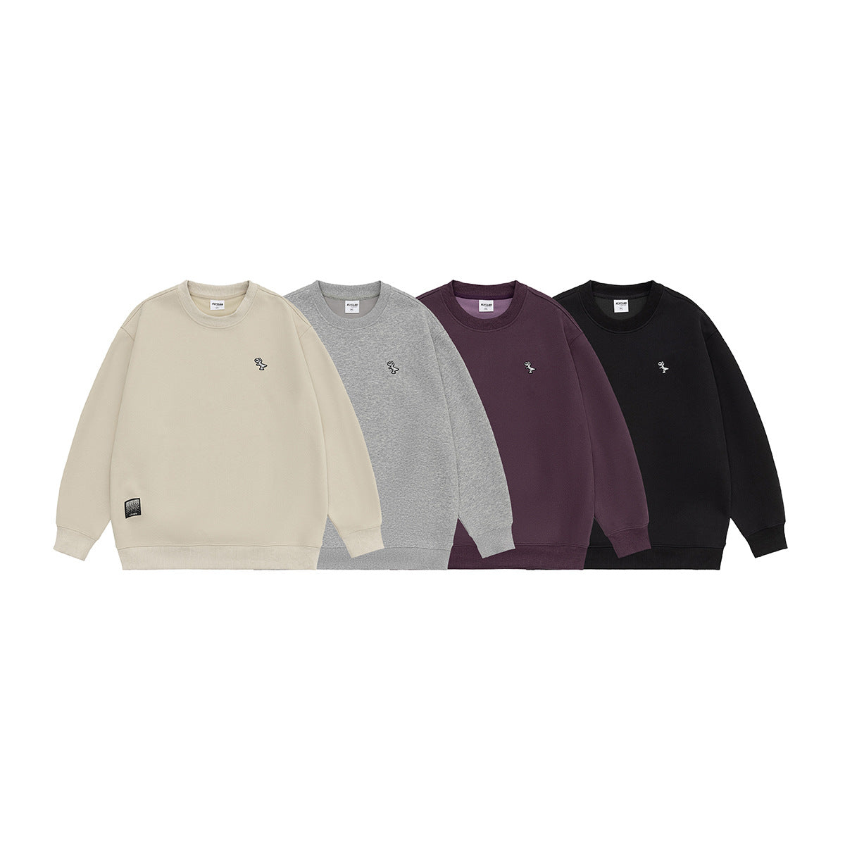 Four crewneck sweatshirts shown together in cream, heather gray, dark plum, and black, each with small chest embroidery.