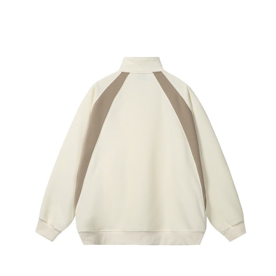 Back view of an ivory zip-up jacket with taupe panels running from the collar down the sides.