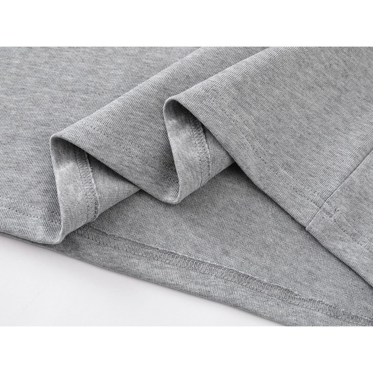 Close-up of the heather-gray shirt's folded sleeve and stitched hem.