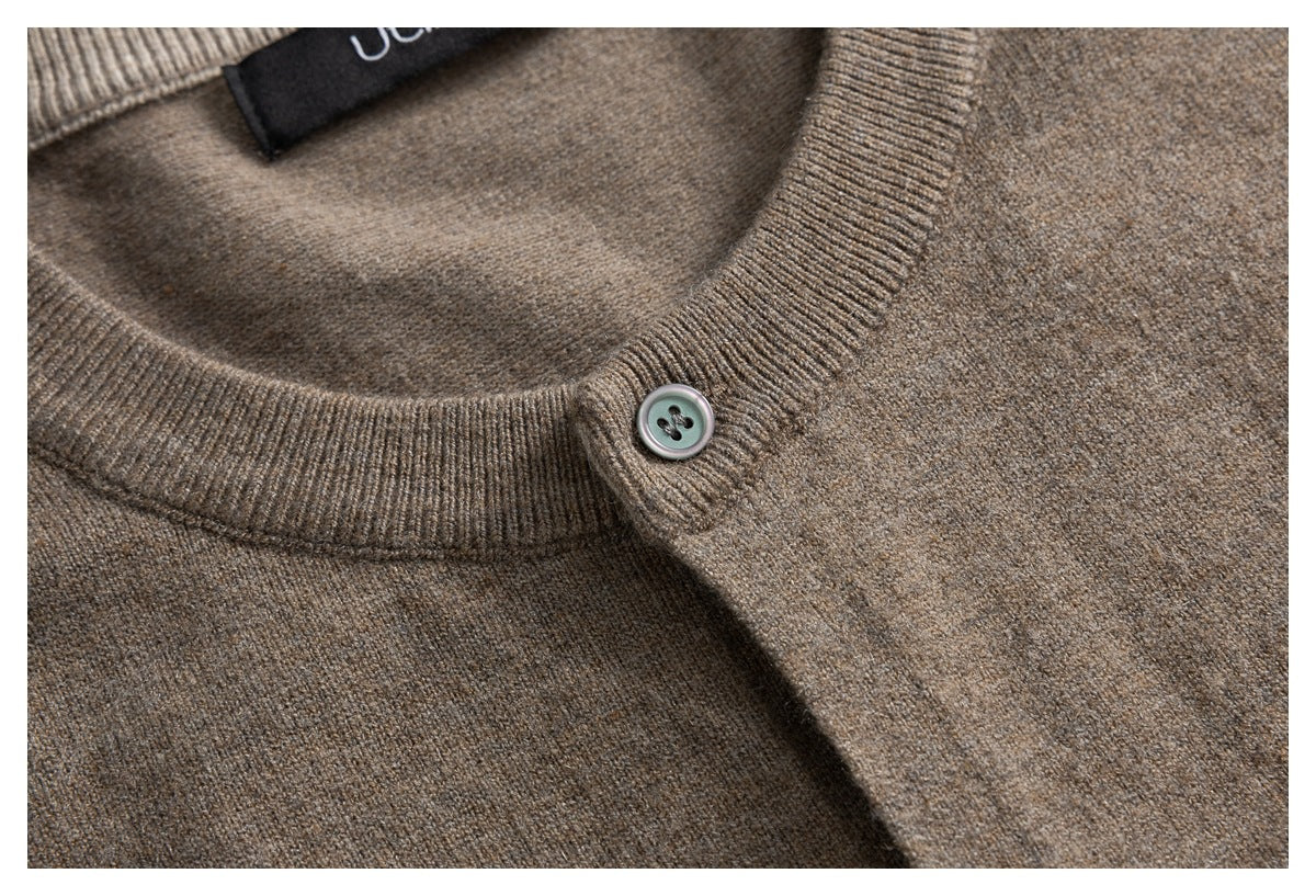 Close-up of a taupe cardigan's ribbed crew neck and button placket.