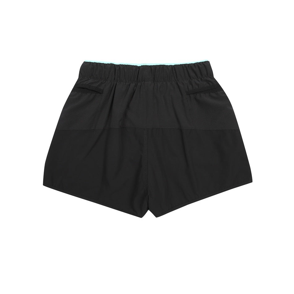 Back view of black shorts laid flat, with an elastic waistband and two rear pockets.