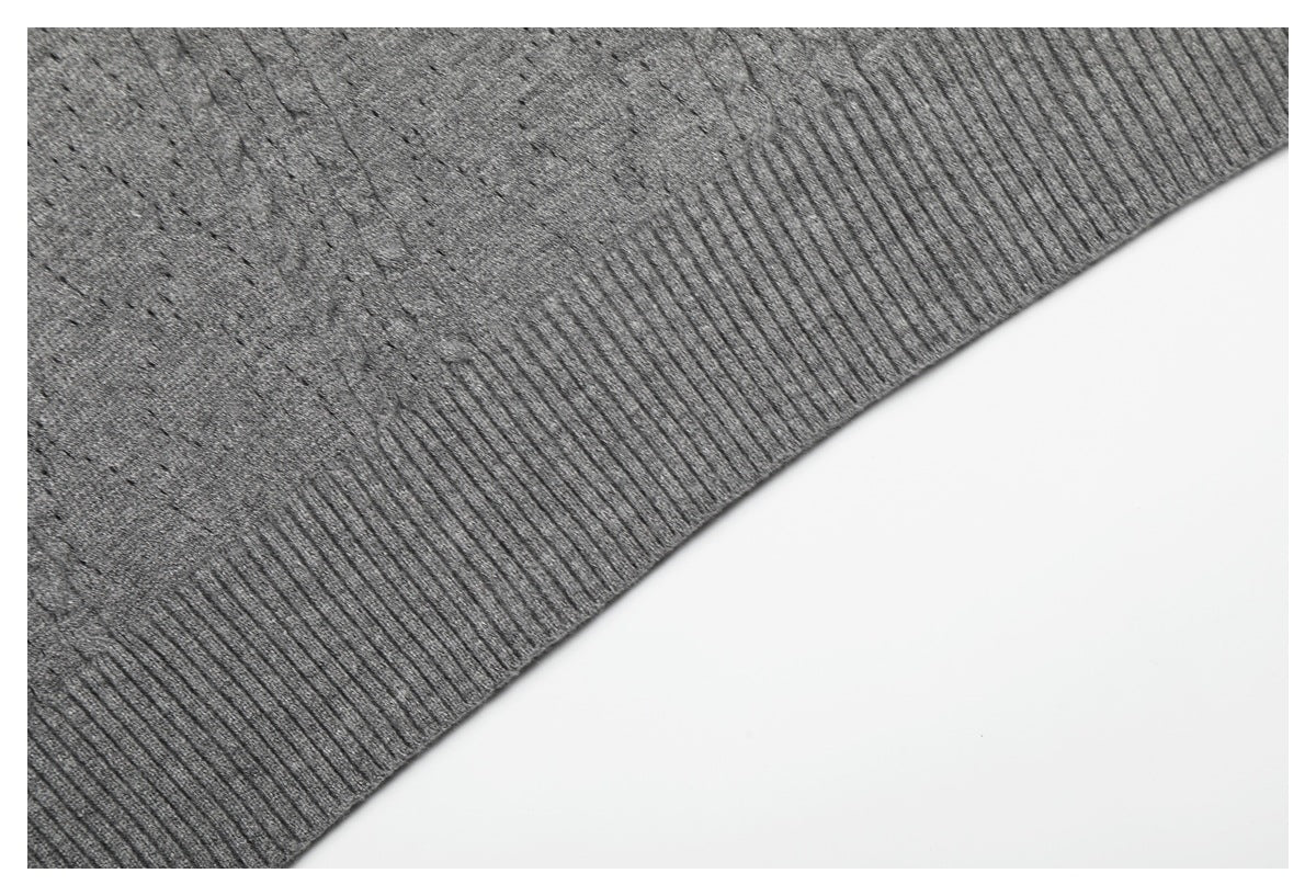 Close-up of the gray knit top's ribbed lower hem and textured body.