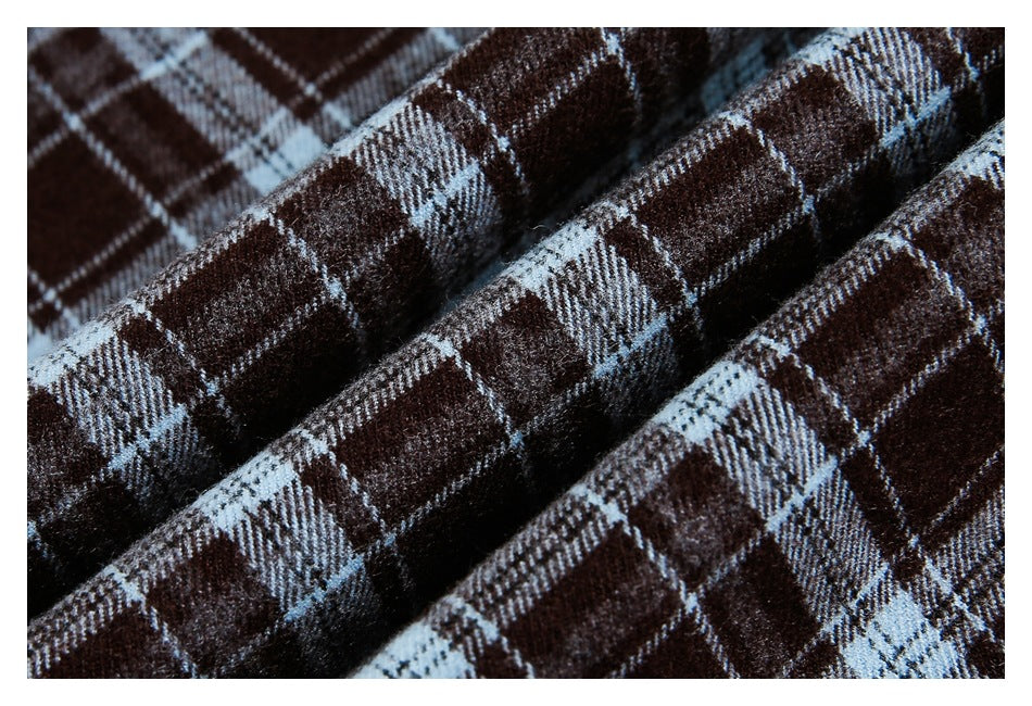 Close-up of brown plaid fabric with pale blue and white intersecting stripes.