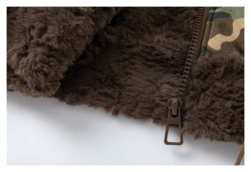 Close-up of dark brown plush lining and a zipper against camouflage fabric.