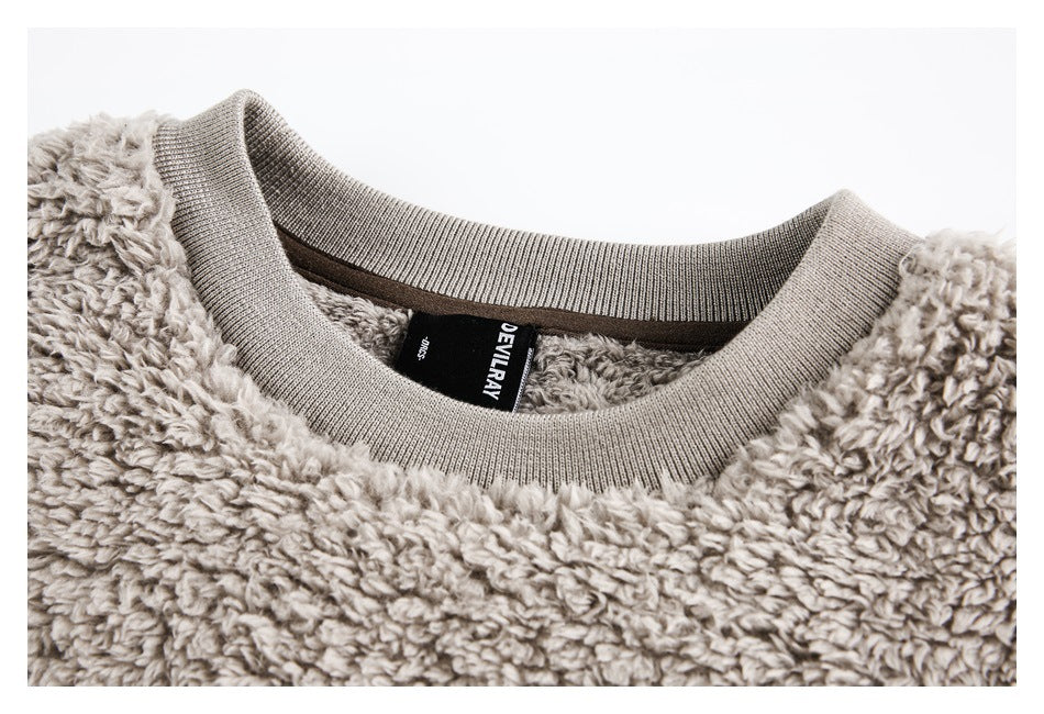 Close-up of the plush sweatshirt's ribbed neckline and inner brand label.