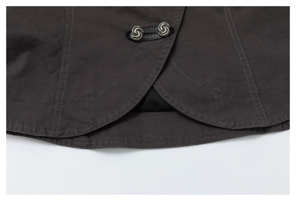 Close-up of the dark charcoal jacket's curved overlapping hem and decorative silver-tone buttons.