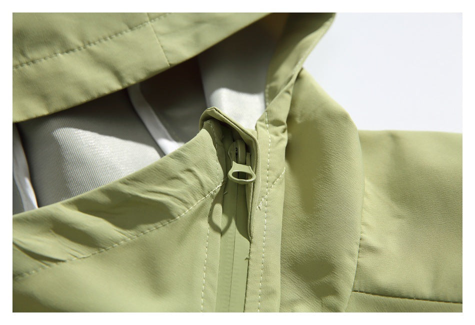 Close-up of the jacket's front zipper pull and stitched placket.