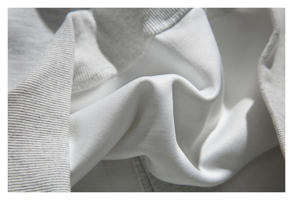 Close-up of light gray fabric with a smooth center panel and ribbed edges.