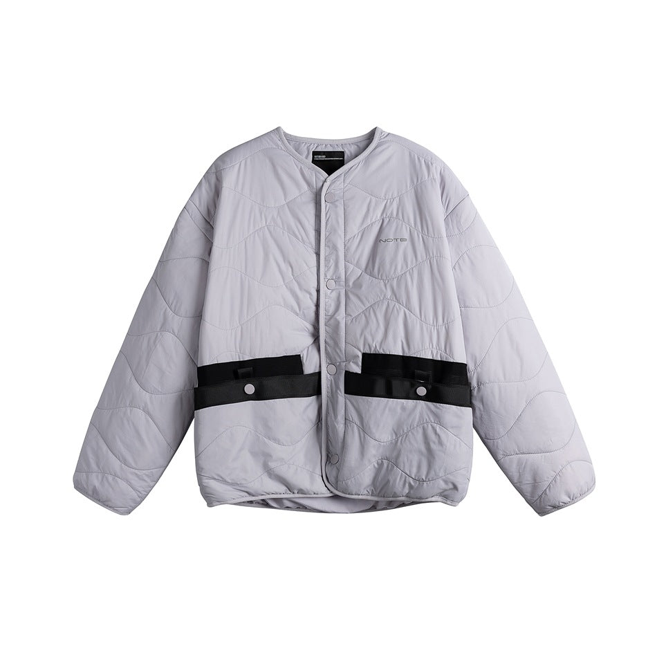 Light lavender-gray quilted collarless jacket, front view, snap buttons and black waist pocket straps