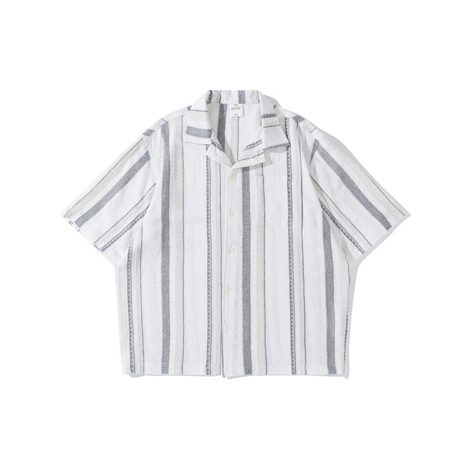 White short-sleeve camp collar shirt with gray and beige vertical stripes, button front and chest pocket, flat lay