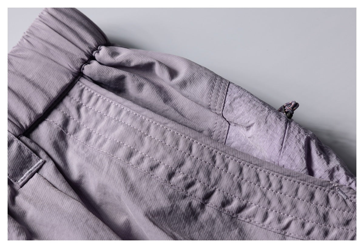 Close-up of the lavender pants' waist and stitched pocket construction.