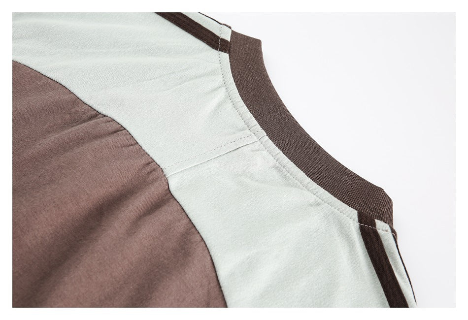 Close-up of a brown ribbed neckline and brown-and-pale-gray color-blocked garment panels.