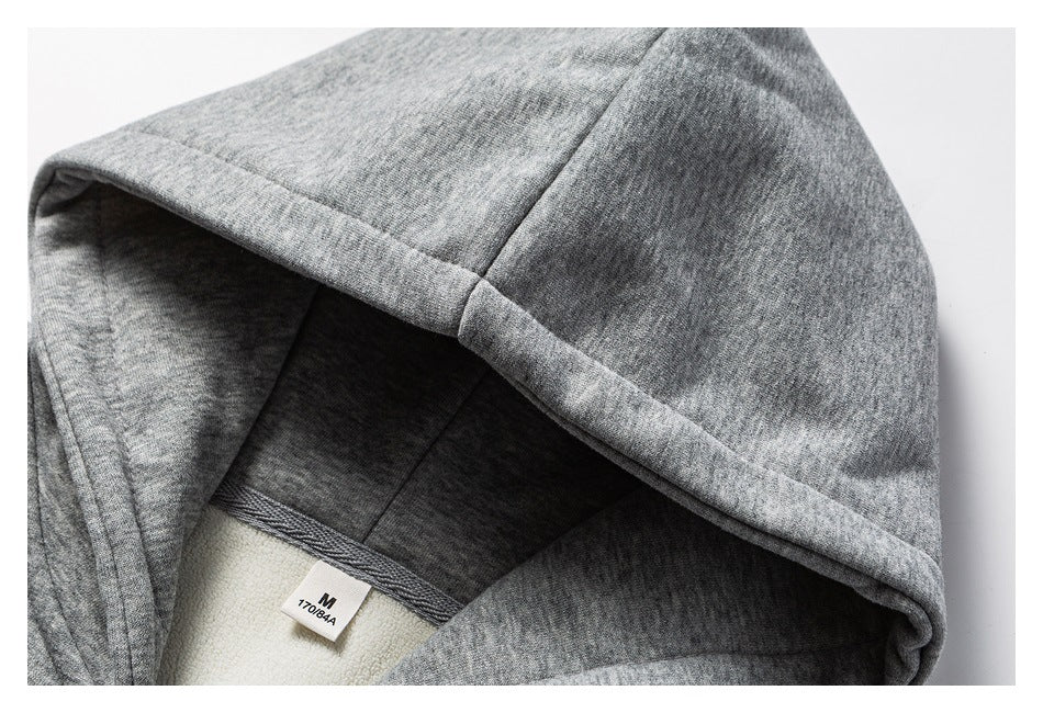 Close-up of a gray sweatshirt hood interior, showing a size label marked M.