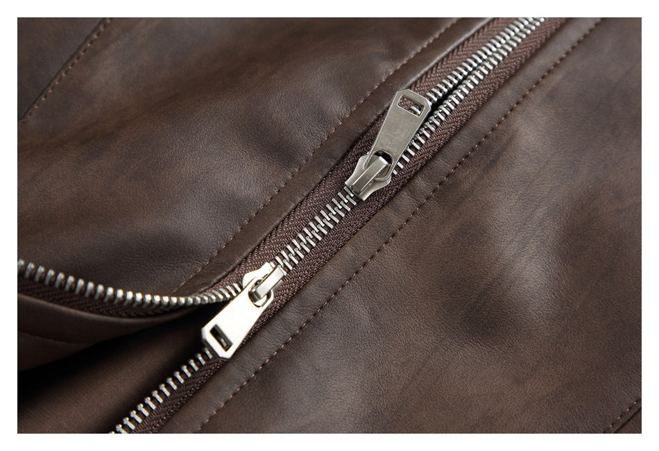 Close-up of the jacket's silver front zipper and brown stitching.