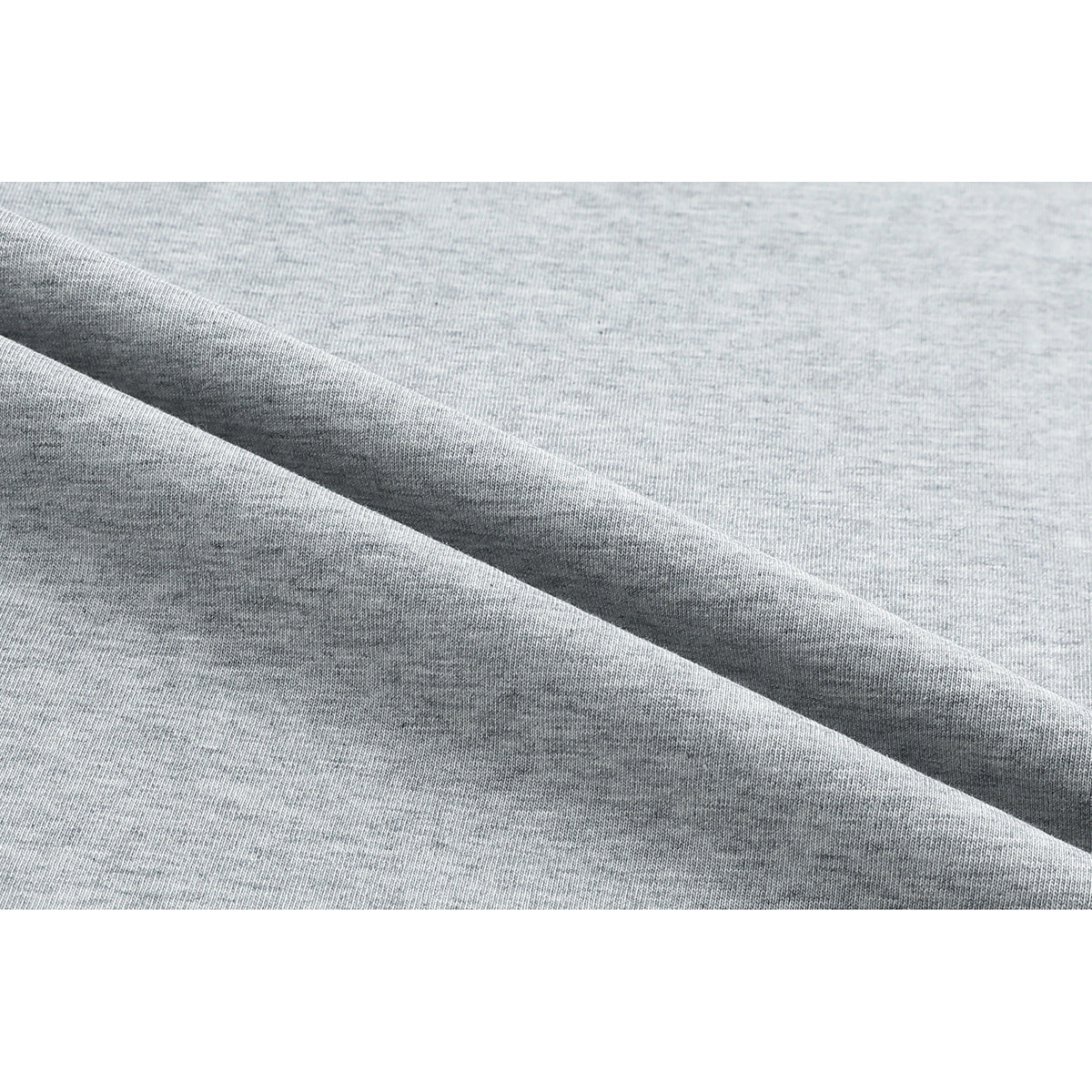 Macro view of light gray heathered knit fabric folded to show its surface and texture.