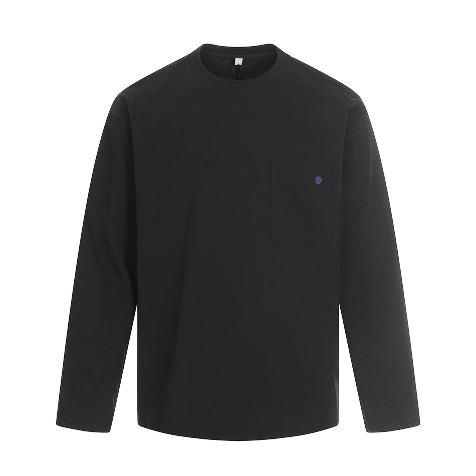Black long-sleeve crew neck top with chest patch pocket and small blue button, flat front view
