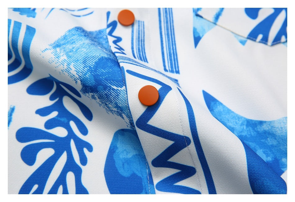 Close-up of the shirt placket with orange buttons and blue abstract shapes on white fabric.