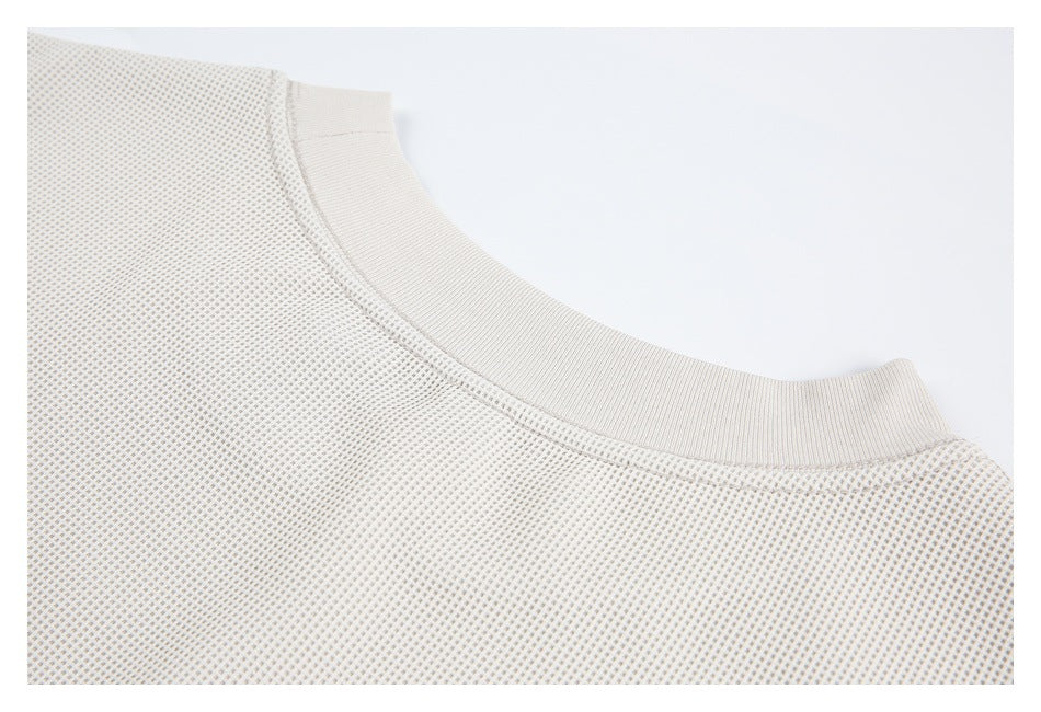 Close-up of the off-white shirt's ribbed crew neckline and textured fabric, viewed from the back.
