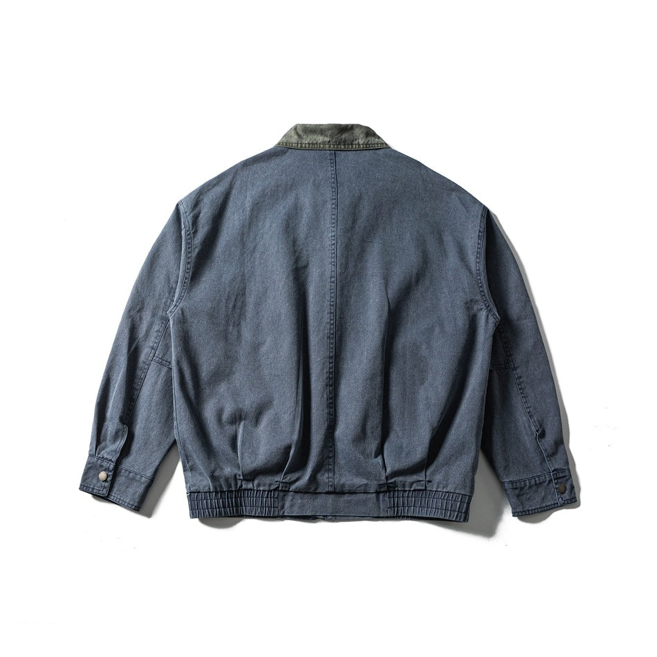 Back view of a blue-gray jacket with a dark contrast collar, center seam, button cuffs, and gathered hem.