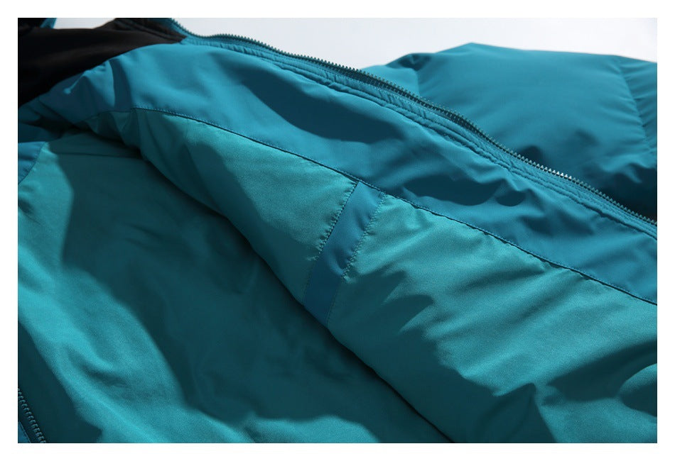 Close-up of the teal jacket's inner panel, stitching, and zipper edge.