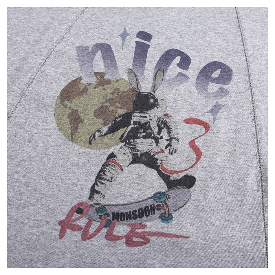 Close-up of a heather gray T-shirt with a colorful astronaut rabbit and skateboard graphic.