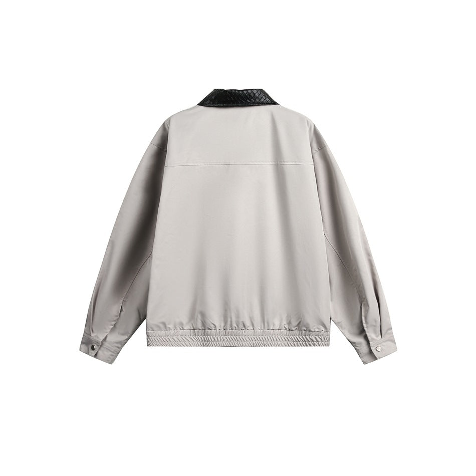 Back view of light gray jacket with black woven-texture collar, yoke seam, ribbed hem and snap cuffs