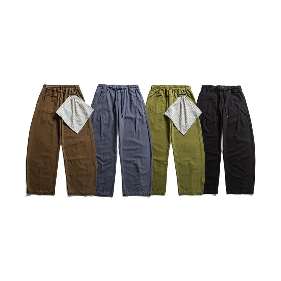 Four pairs of drawstring pants in brown, slate blue, olive, and black, shown flat with plaid fabric swatches.