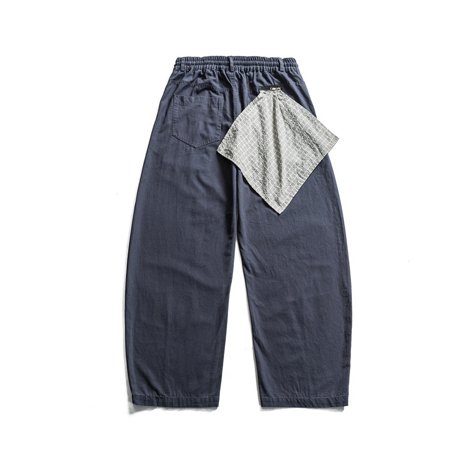 Back view of blue-gray wide-leg pants with elastic waistband, patch pocket and gray checked cloth at the waist