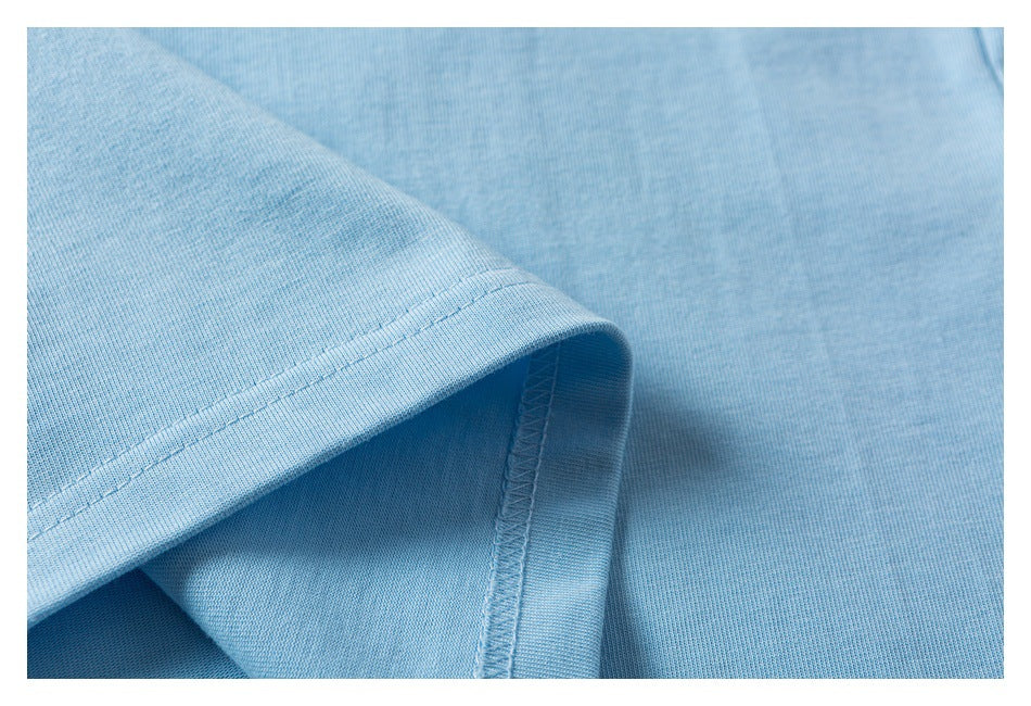 Close-up of a light blue garment hem with double stitching and an interior overlock seam.