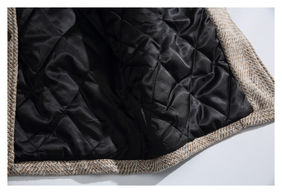 Close-up view of the black quilted interior lining bordered by tan and brown herringbone fabric.