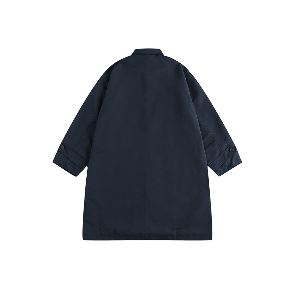 Back view of a dark navy long coat with a center seam, short collar, and buttoned sleeve tabs on a white background.