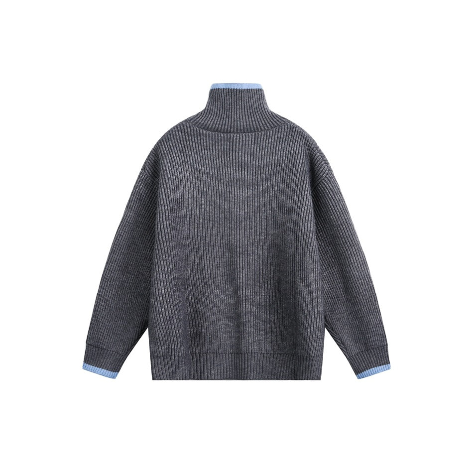 Back view of gray ribbed-knit cardigan with high stand collar and light blue trim at collar and cuffs