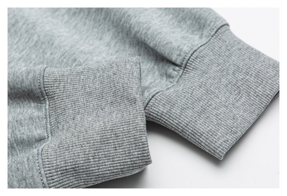 Close-up of ribbed cuffs on a heather gray sweatshirt.
