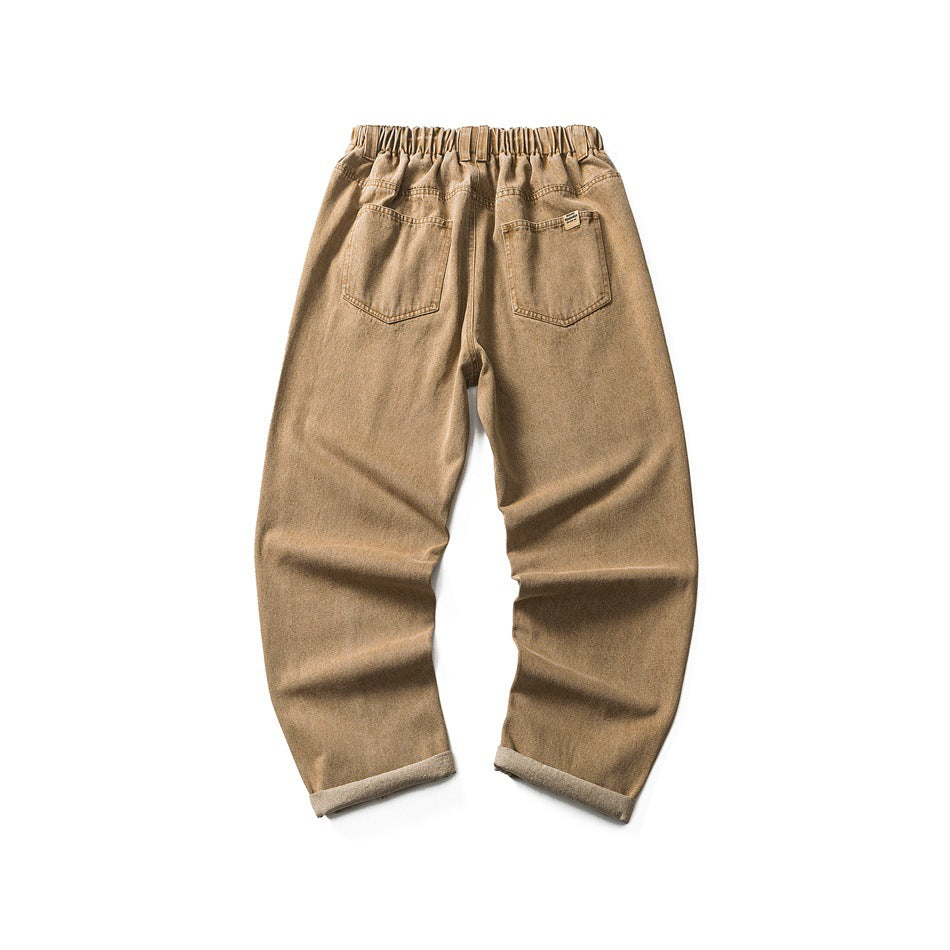 Back flat lay of khaki jeans showing elastic waistband, two patch pockets and cuffed hems