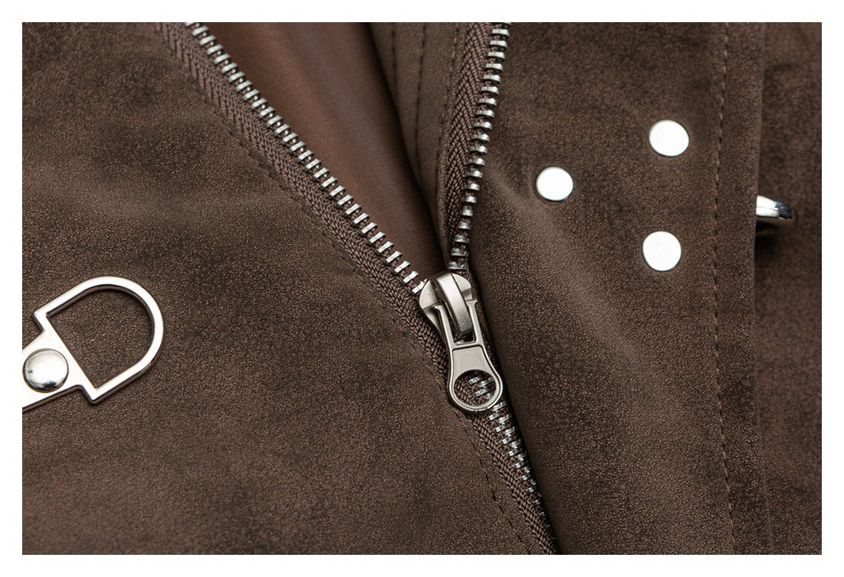 Close-up of a dark brown garment with a metal zipper, snap fasteners, and metal loop hardware.