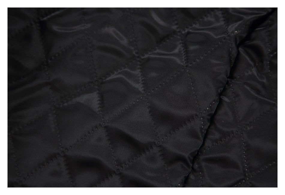 Close-up of the coat's black lining with diamond-shaped quilting.