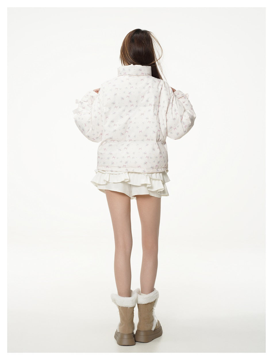 Back view of a model wearing the white pastel bow-and-floral print jacket with ribbon-tied cuffs.
